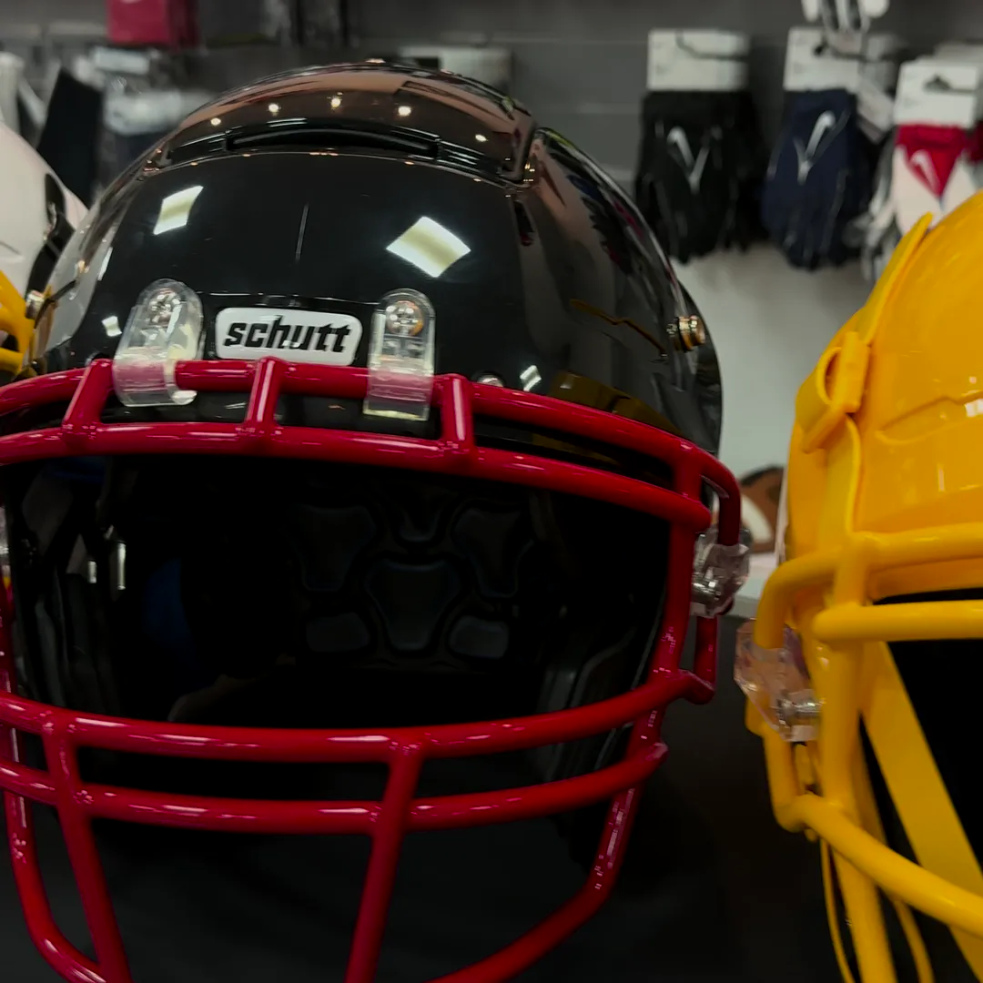 Black Schutt F7 football helmet with red facemask at the DOC A SPORTS store